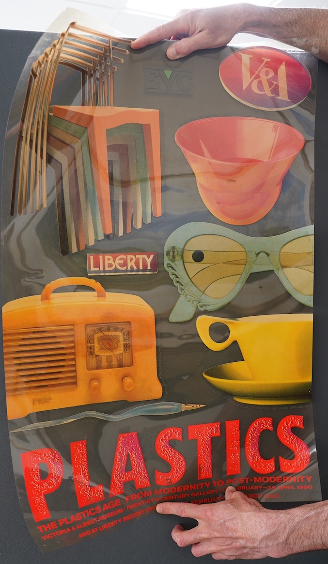 An amber tinted cellulose acetate (or possibly polyester) poster advertising the Victoria and Albert 1990 exhibition; The Plastic Age - From Modernity to Post-Modernity, 76cm x 51cm. Condition - fair to good